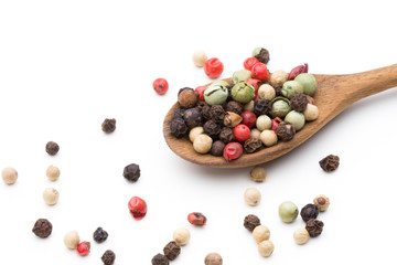 Pepper mix seed on spoon on white background.