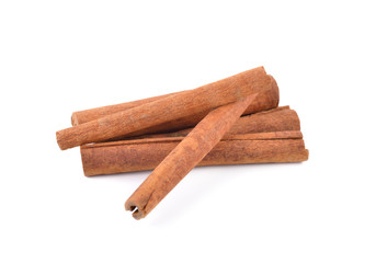 pile of dried cinnamon stick on white background