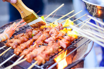 Steak and sauce on the table with dipping sauce on the meat, decorated with vegetables and french fries blurred photo