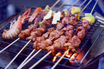 Steak and sauce on the table with dipping sauce on the meat, decorated with vegetables and french fries blurred photo