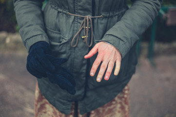 Woman with raynaud disease outdoors in winter - 243322335