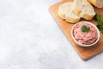 Baked chicken pate in a plate and pieces of bread on the Board. Copy space.