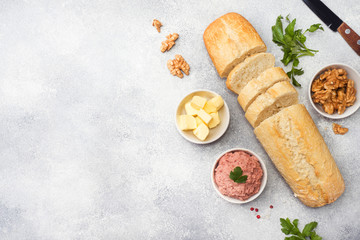 Products for cooking a sandwich. Chicken pate and butter, nuts and parsley.