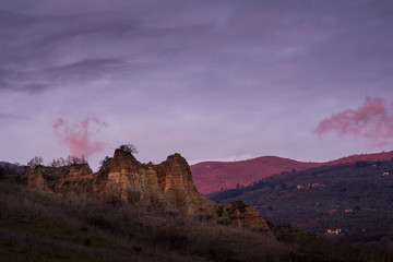 landscape with mountains and clouds, le balze del valdarno in tuscany at sunset