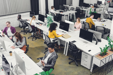 high angle view of young multiethnic business people working in open space office