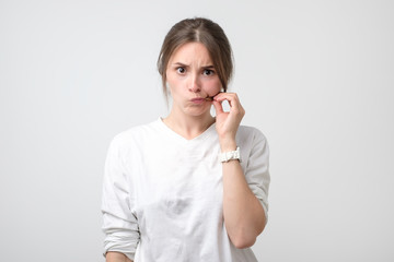 Caucasian pretty woman zipping her mouth shut. Keeping quiet concept