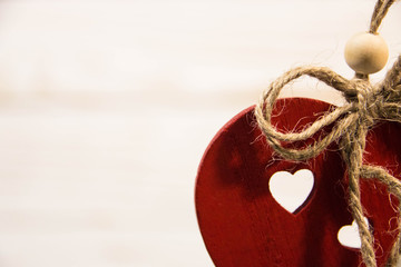 handmade red heart close-up on white wooden background, symbol of love, happy Valentine's Day