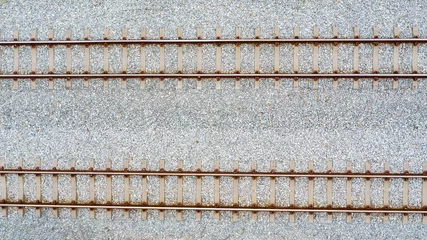 Schilderijen op glas Top view of railroad tracks and abstract background © Sunday Stock