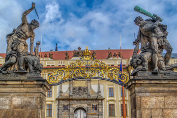 Fototapeta premium Statue of Battling Titan over the front gate of Hradcany Castle in Prague (Praha), Czech Republic