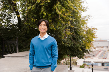 Fototapeta premium Confident smiling asian businessman standing