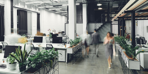 modern open space office interior with blurred business colleagues - obrazy, fototapety, plakaty