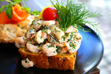 Scandinavian Smorrebrod open-faced sandwich with cold shrimp in Denmark 