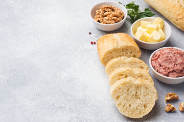 Products for cooking a sandwich. Chicken pate and butter, nuts and parsley.