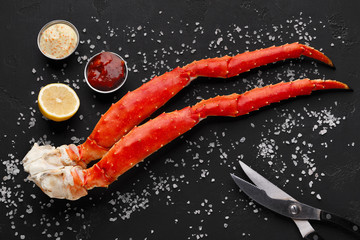 Delicious king crab legs with eating tools top view © Prostock-studio