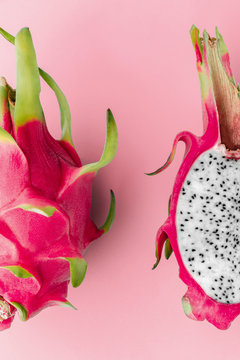Fresh organic dragon fruit on a pink background, creative summer food concept