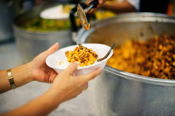 Hands of beggars accepting food from the hands of volunteers who come to help free food breaks.