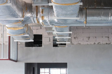 Typical installation of ducting with fiberglass insulation work pass through to wall