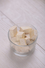 Fototapeta na wymiar Tofu cubes in a glass