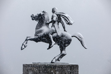 heavy snowfall at the city center. statue of Alexander the Great at the city waterfront