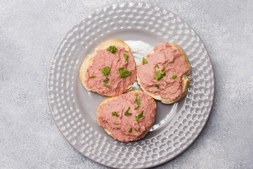 Sandwiches with chicken pate and butter on the table.
