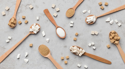Collection of different kinds of sugar on gray background