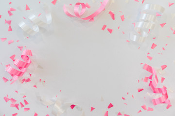 close up on group of white and pink rolling ribbon and confetti on white background with copy space for valentine's day  festival happy new year ,carnival , birthday and anniversary, concept design	