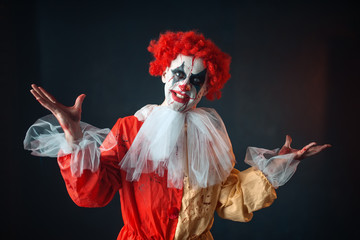 Portrait of scary bloody clown with crazy eyes