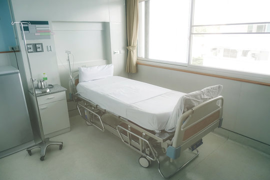 Empty hospital bed in hospital ward