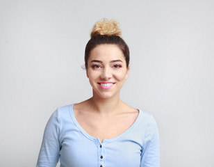 Portrait of pretty smiling woman posing on background