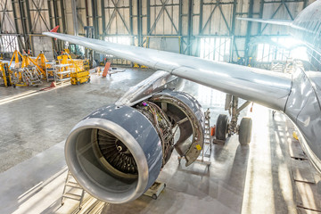 Opened aircraft engine in the hangar, maintenance. Wing view