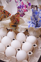 Chicken white eggs ready to decorate with pieces of colored fabric for Easter. Close-up.