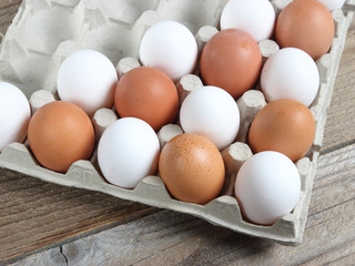 White and beige eggs, close-up, in a package.