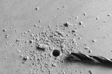 top view, close up, metal drill bit make holes in a wooden fibreboard panels, surface, kitchen...