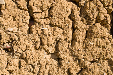 Old wall plastered with mud closeup