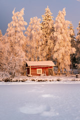 Red little winter cabin Finland