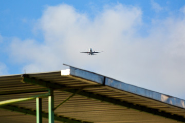 Passenger airplane landing against blue cloudy sky in Brazil
