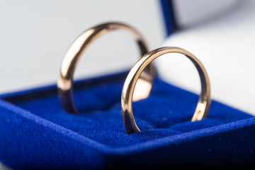 gold wedding rings in the blue jewelery box