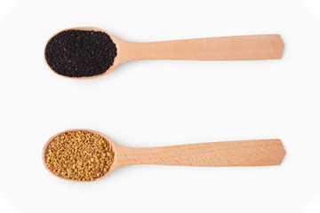 Wooden spoons with aromatic culinary condiments on white