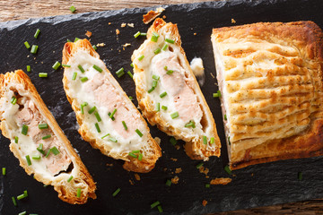 Baked salmon pie with cheese close-up. horizontal top view