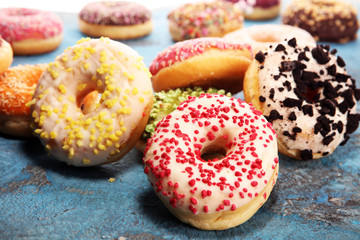 assorted donuts with chocolate frosted, pink glazed and sprinkles