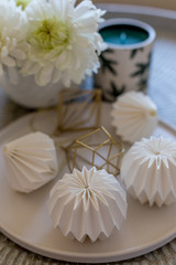 White origami decorations in white plate.