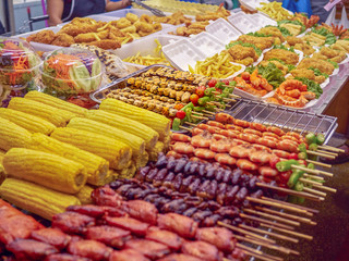 Street food on sticks in Phuket (Thailand). Corn cobs, pork, chicken, shrimp and other food.