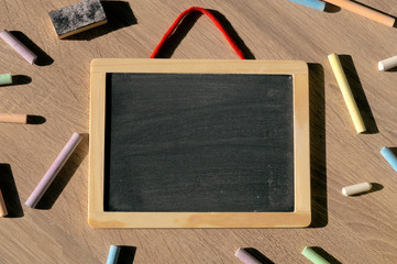 Clean blackboard and colorful chalks.