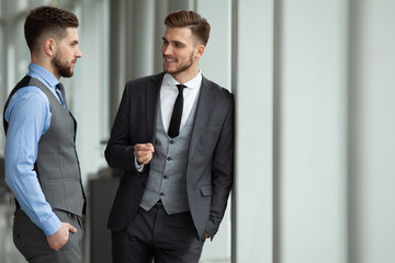 Two business colleagues at meeting in modern office interior.
