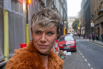 Beautiful young woman looking down a street