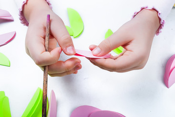 Child cuts an eggs for Easter out of paper.