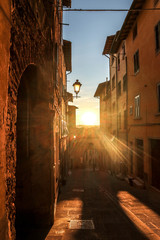 Narrow street in a little tuscany town Castelfiorentino at the sunset, Italy