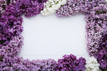 Beautiful purple lilac flowers on white wooden table