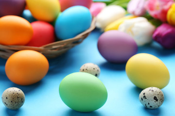 Fototapeta na wymiar Colorful easter and quail eggs on blue background