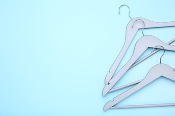 Wooden grey hangers on blue background